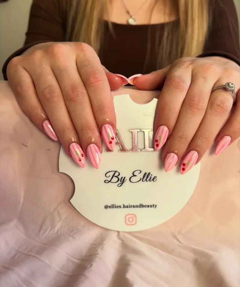 Pink striped nails with cherry nail art