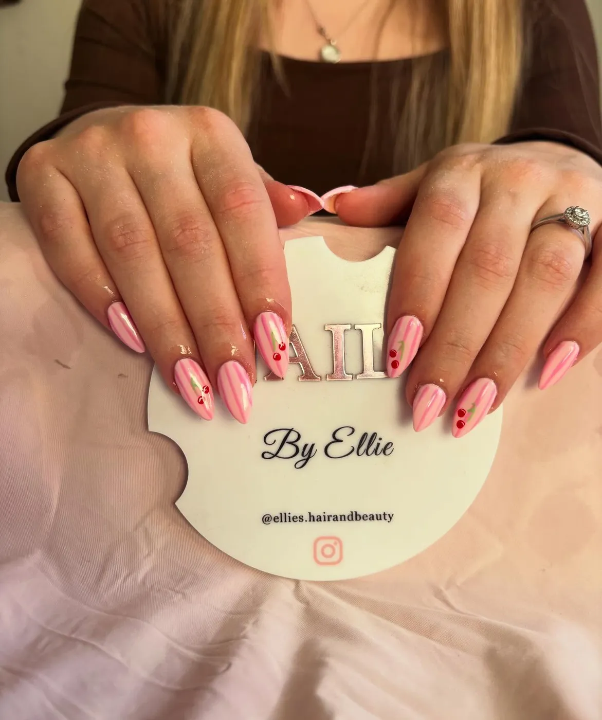 Pink striped nails with cherry nail art