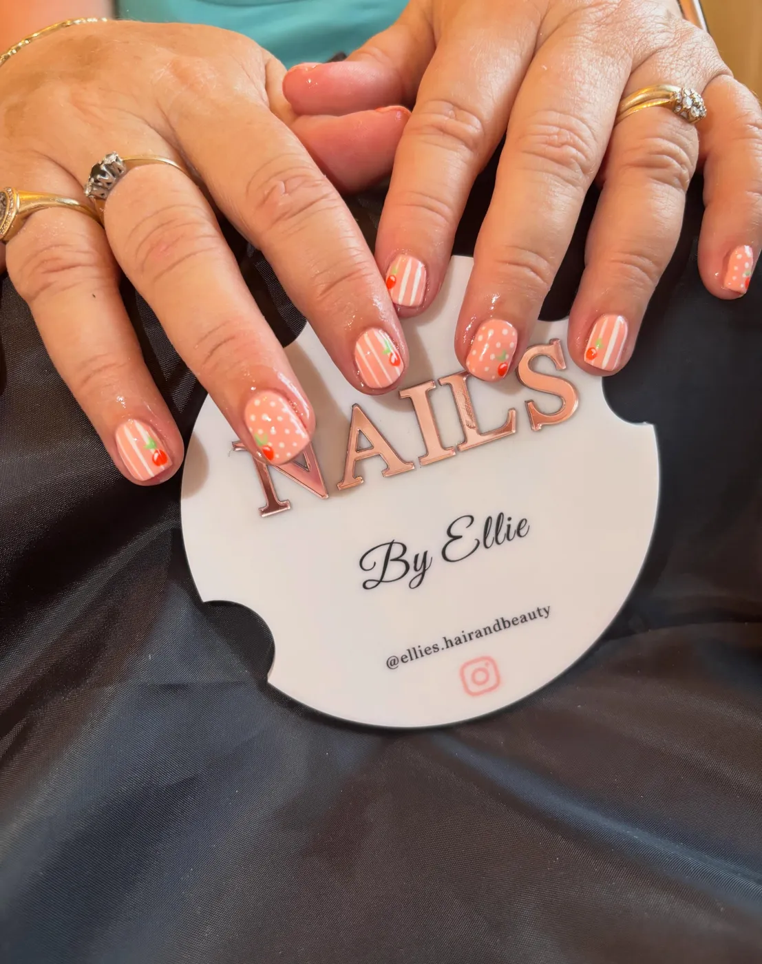 Peach striped nails with cherry and polka dot nail art